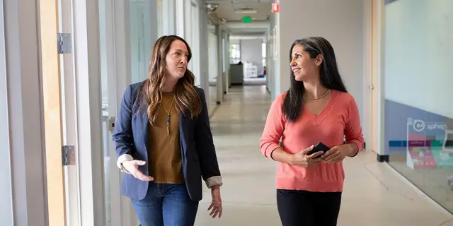 Two members of the AFX Research team walking through the company's San Luis Obispo offices
